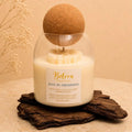 Dive in Freshness candle by Belora Handcrafts in a glass jar with a cork ball lid, set on a piece of bark